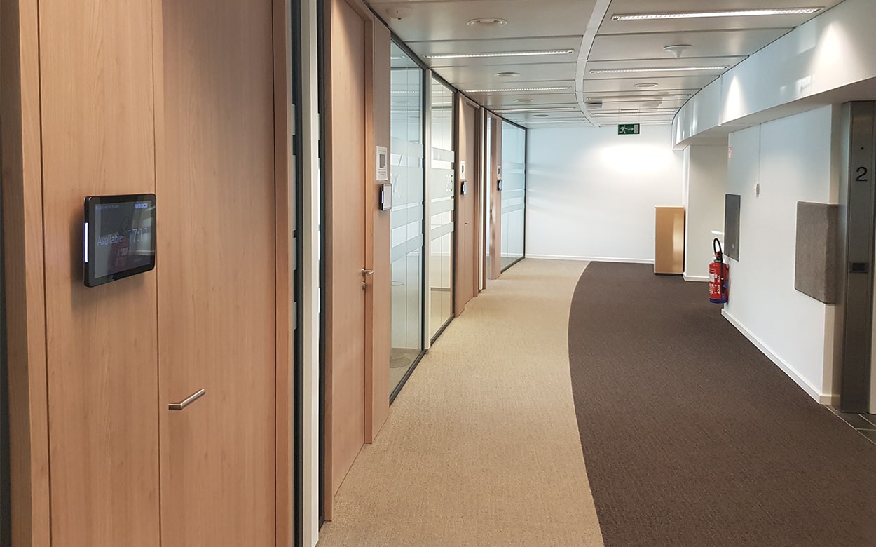 Corridor at Wabco with meeting rooms and Meetio Room tablets