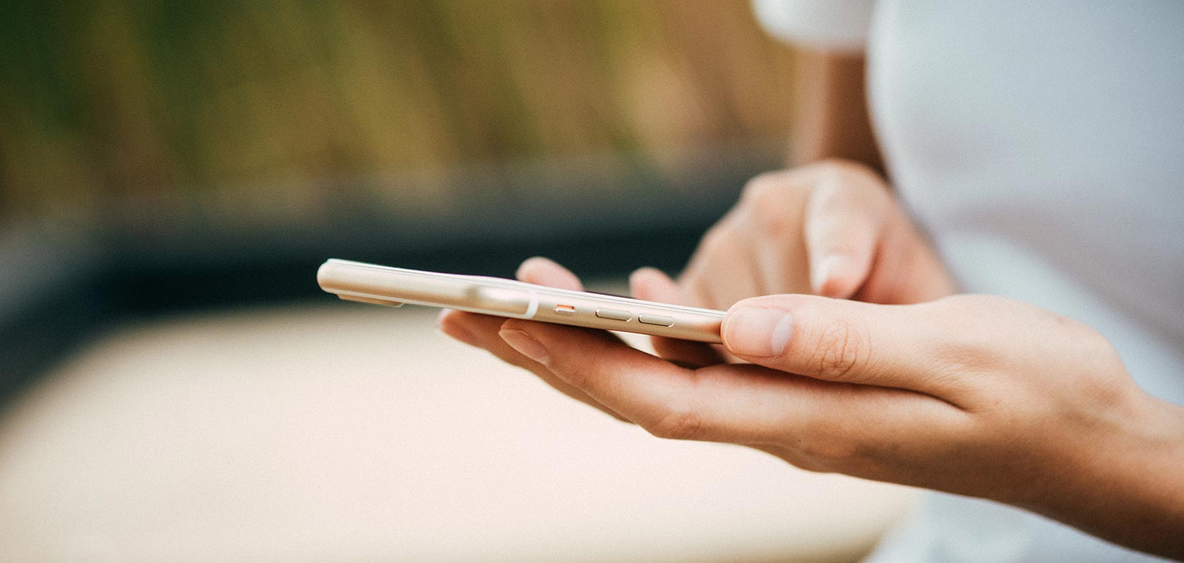 Woman holding an iPhone in her hand