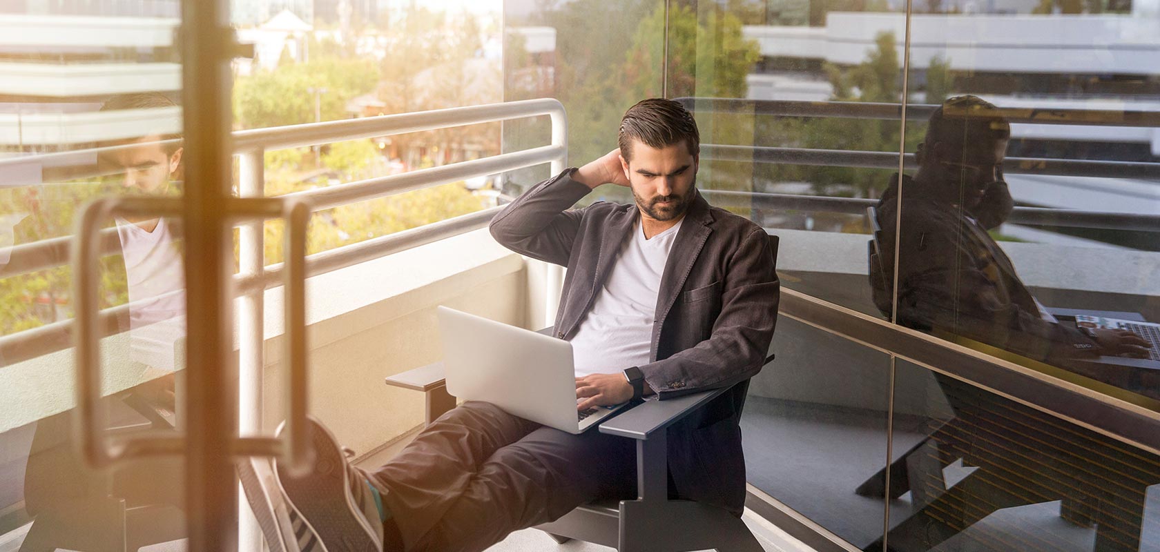 Man working outside with a laptop