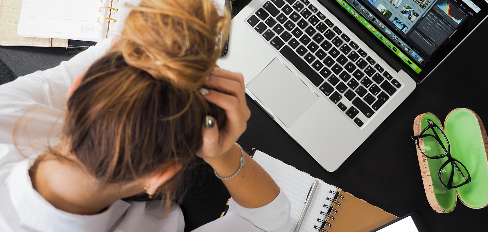 Frustrated woman looking down at her desk